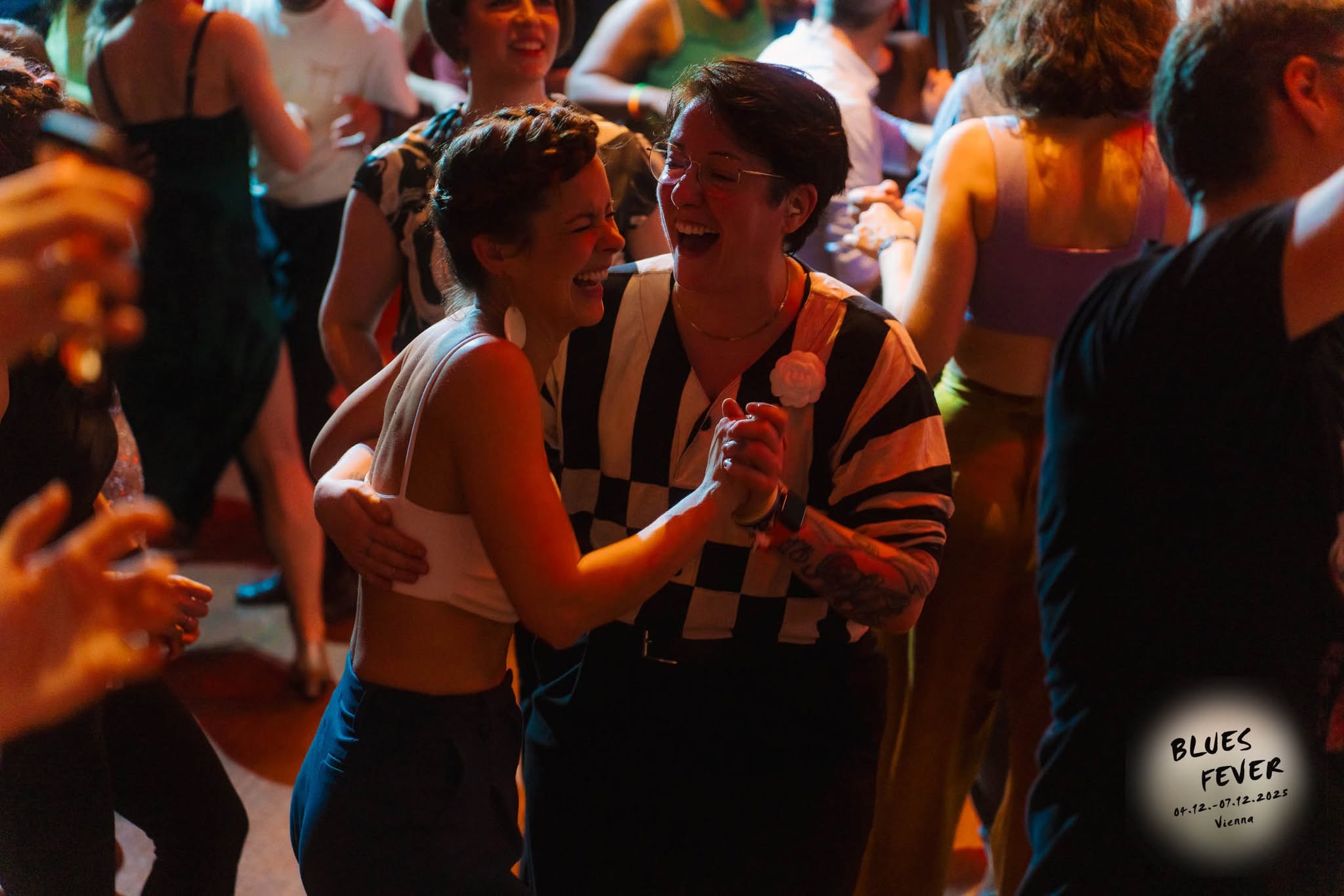 Two dancers laughing on the Blues Fever dance floor