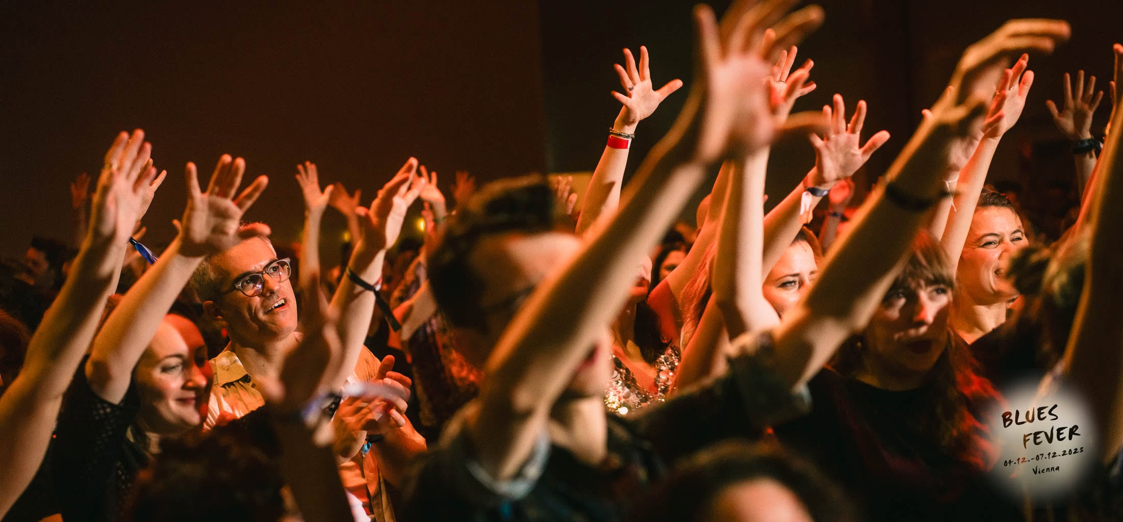 Blues Fever audience with raised hands